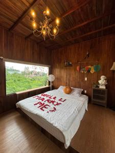 a bedroom with a bed with red flowers on it at Nhà Bên Đồi in Thôn Dương Phẩm +10 photos