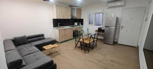 a living room with a couch and a kitchen at Exquisite Flat in Martorell (Barcelona) in Martorell +8 photos