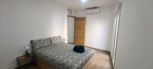 a bedroom with a bed with a blue backpack on it at Exquisite Flat in Martorell (Barcelona) in Martorell