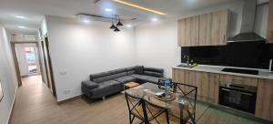a kitchen and a living room with a couch and a table at Exquisite Flat in Martorell (Barcelona) in Martorell