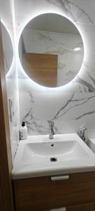 a bathroom with a white sink and a mirror at Exquisite Flat in Martorell (Barcelona) in Martorell