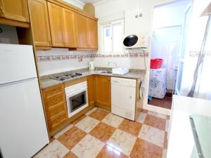 a kitchen with wooden cabinets and a white refrigerator at Enjoy a stylish experience at this centrally-located place ! in Dublin