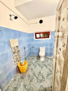 a bathroom with a toilet and a shower at Puspalay Homestay in Guwahati