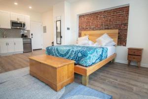 Un dormitorio con una cama y una pared de ladrillo. en Diamond Suites Philadelphia Center, en Filadelfia