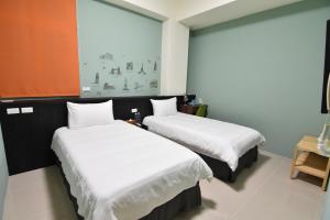 Tempat tidur dalam kamar di Com Inn-花蓮後車站電梯停車場