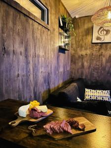 a table with a cutting board and some meat on it at Lillahuset in Sundsvall