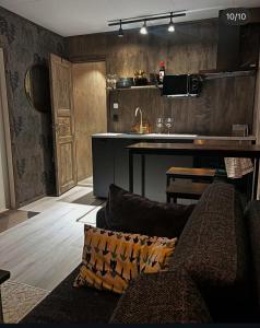 a living room with a couch and a kitchen at Lillahuset in Sundsvall +5 photos