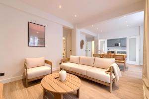 a living room with a couch and a table at San Mamés Apartment in Bilbao