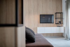 a living room with a tv on a wall at The Bellevue Lodge in Lopar