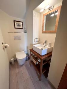 a bathroom with a white sink and a toilet at L'Appaltino Cuore Medievale di Radicofani in Radicofani