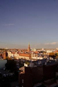 a view of a city with buildings and a church at Kawa z widokiem na jesienny Bytom, 50m2 in Bytom