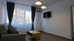 a living room with a couch and a coffee table at Chic and sunny downtown apartment in Braşov