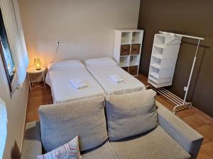 a small room with two beds and a couch at Chalet Rural Toñita 400 m playa piscina barbacoa chimenea in Bueu +25 photos