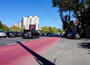 a shadow of a car parked on a city street at Chic and sunny downtown apartment in Braşov