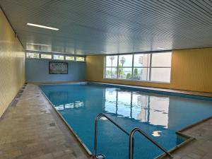 a large indoor swimming pool in a building at Palme 004 by Fewotessin in Locarno