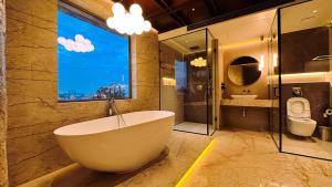 a bathroom with a tub and two sinks and a window at FHotels in Bengaluru +110 photos