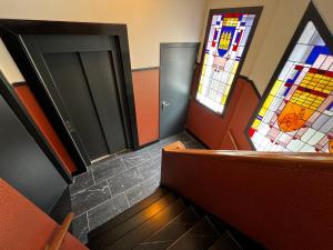 a room with a staircase with stained glass windows at Central Tilburg Apartments in Tilburg