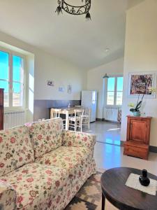 a living room with a couch and a table at Il casale di Sere Tarquinia in Tarquinia