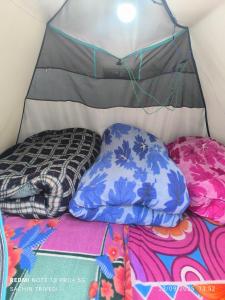 a bed in a tent with pillows on it at Trivedi Camps in Kedārnāth