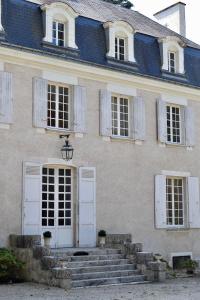 a building with white doors and stairs in front at Château de Chavigny in Chambourg-sur-Indre