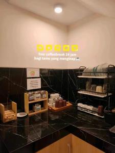 a store with a black counter top with a sign at The Cabin Hotel Sidoarum in Sleman