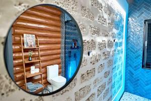a bathroom with a mirror and a toilet in a room at Koshara chalet - harmony in the midst of nature in Mriia +58 photos