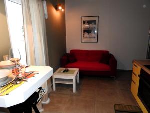 a living room with a red couch and a table at Delight Loft in Rovinj