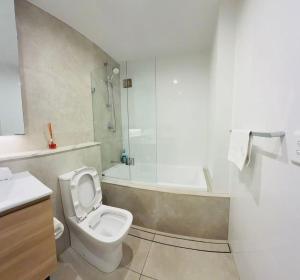 a bathroom with a toilet and a shower and a sink at Schofields Brand New 2 Br Apt Parking Privacy in Schofields