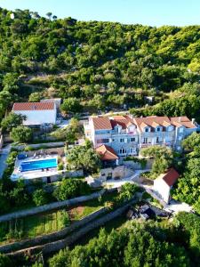 an aerial view of a house with a swimming pool at Boutique Hotel Tomić in Lopud Island