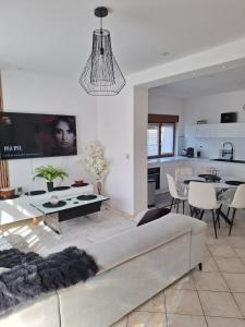 a living room with a couch and a table at Maison bella secteur calme in Rouvroy +37 photos