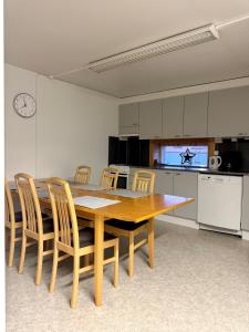 a dining room table and chairs in a kitchen at Arctic Elf Apartment in Rovaniemi +5 photos
