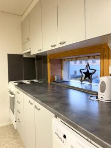 a kitchen with a counter top with a star on it at Arctic Elf Apartment in Rovaniemi