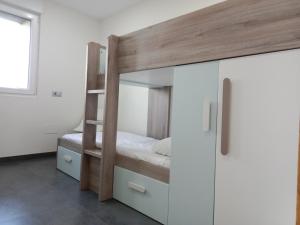 a bedroom with a bunk bed and a white cabinet at Abril 56 Villa&Suites in Oreña