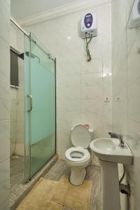 a bathroom with a shower and a toilet and a sink at Shabi's Court in Lagos +43 photos