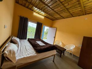 a bedroom with a bed and a window at Datta's Heritage in Chaubattia