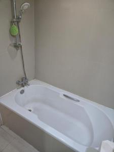 a white bath tub in a bathroom with a shower at Studio apartment in Trendy Bankok in Bangkok +11 photos