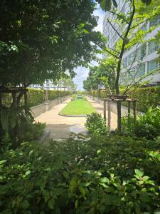 a walkway in a park with trees and a building at Studio apartment in Trendy Bankok in Bangkok