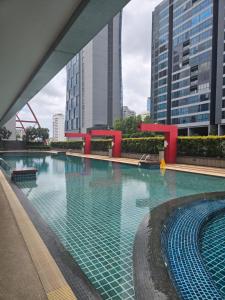 a large swimming pool in a city with tall buildings at Studio apartment in Trendy Bankok in Bangkok