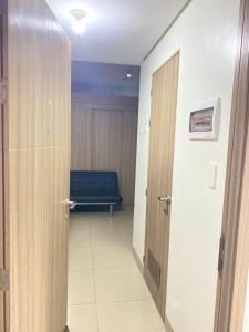 a hallway with a door and a bench in a room at Shore 2 tower 2 in Manila +2 photos