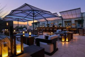 a restaurant with tables and chairs and a bar at Nobu Hotel Roma in Rome