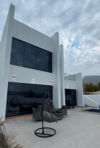 a large white building with a spiral at Camellia chalet in Muhya