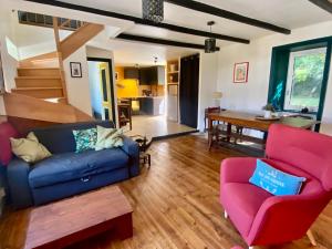 a living room with a couch and two chairs at Maison cosy à 5 min de la plage de Poulziourec ! - FR-1-813-32 in Groix
