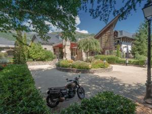 a motorcycle parked in a parking lot in front of a building at Appartement T2 sud, calme, proche Saint-Lary, 4 pers. - FR-1-296-523 in Bourisp +7 photos