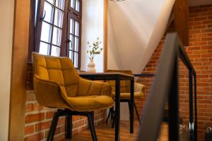 a room with a table and two chairs at Apartamenty Rynek 13 in Grudziądz