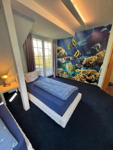 a bedroom with a fish mural on the wall at Ferienwohnung im Poolhaus mit Ostseeblick in Wittenbeck +12 photos