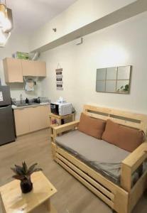 a living room with a bed and a kitchen at The Stayhaus by Dan & Steph in Manila