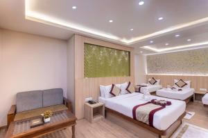 a hotel room with two beds and a couch at Royal Boutique Hotel in Kathmandu