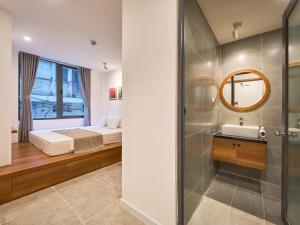 a bedroom with a bed and a sink and a mirror at The Midnight Lotus Saigon-Urban Retreat with Private Balcony-Free Laundry in Ho Chi Minh City +207 photos