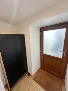 an empty room with a door and a window at 18 m studio in Orelle 73140 in Orelle