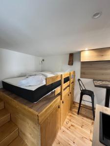 a bed on a wooden platform in a room at 18 m studio in Orelle 73140 in Orelle